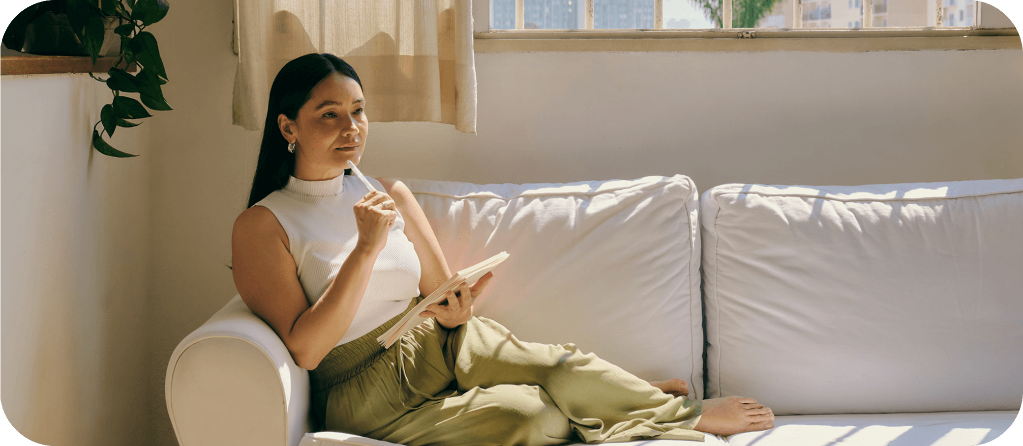 Woman relaxing on a couch with a notebook